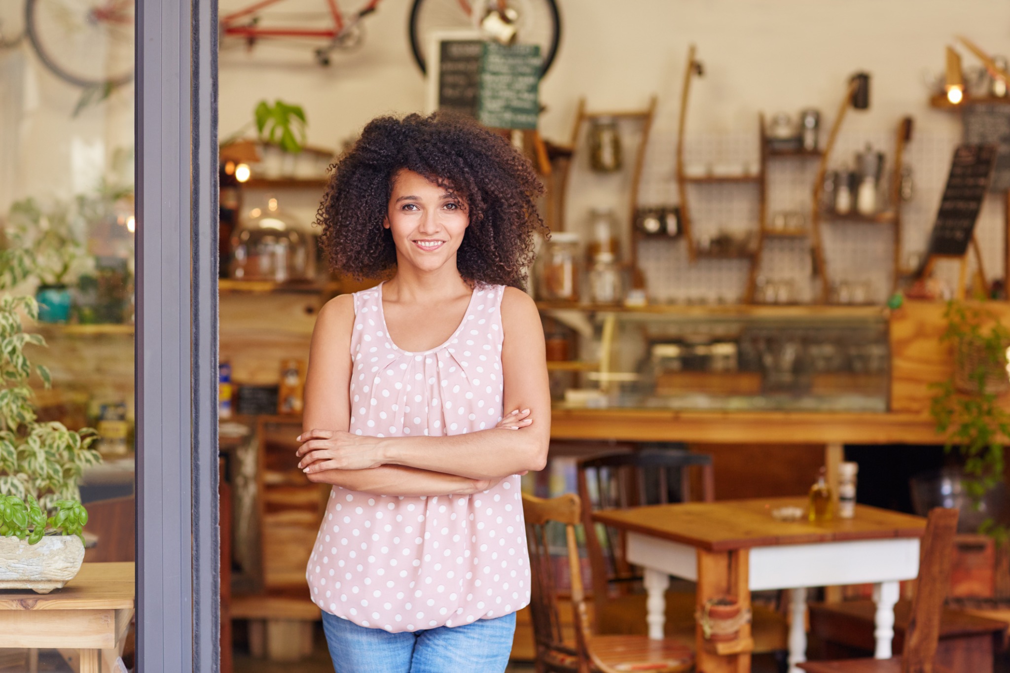 Independent small-business owner standing confidently inside her storefront
